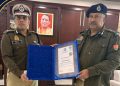 IG Kiran S receiving Interpol Medal of Excellence certificate, UP Police international award ceremony, Rajeev Krishna DGP handing certificate to Kiran S, Interpol General Assembly Morocco session image